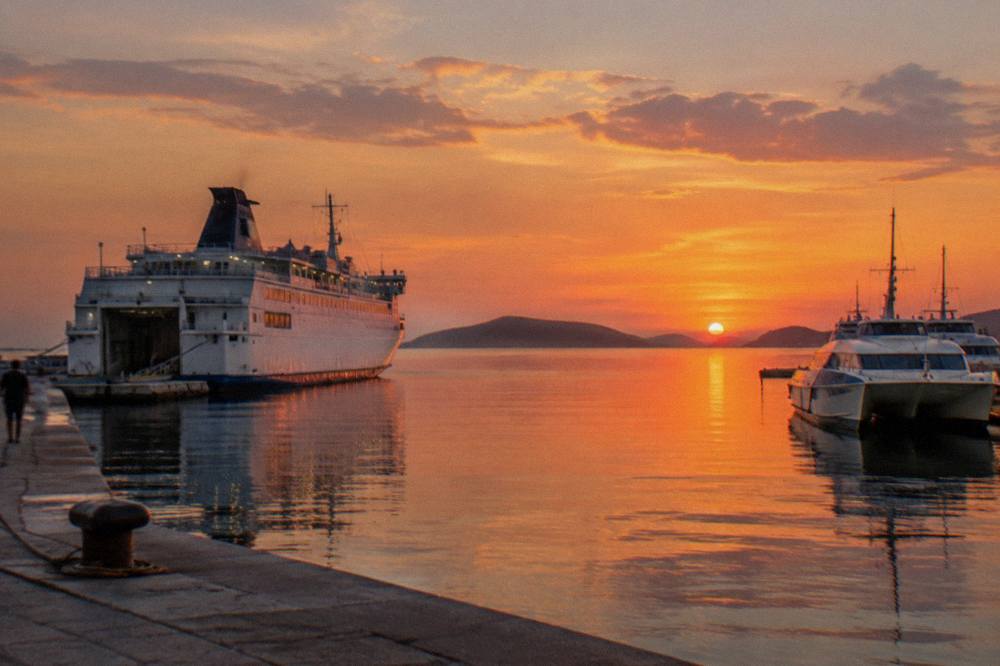 White ferry and catamarans moored at the Split passenger port at dusk