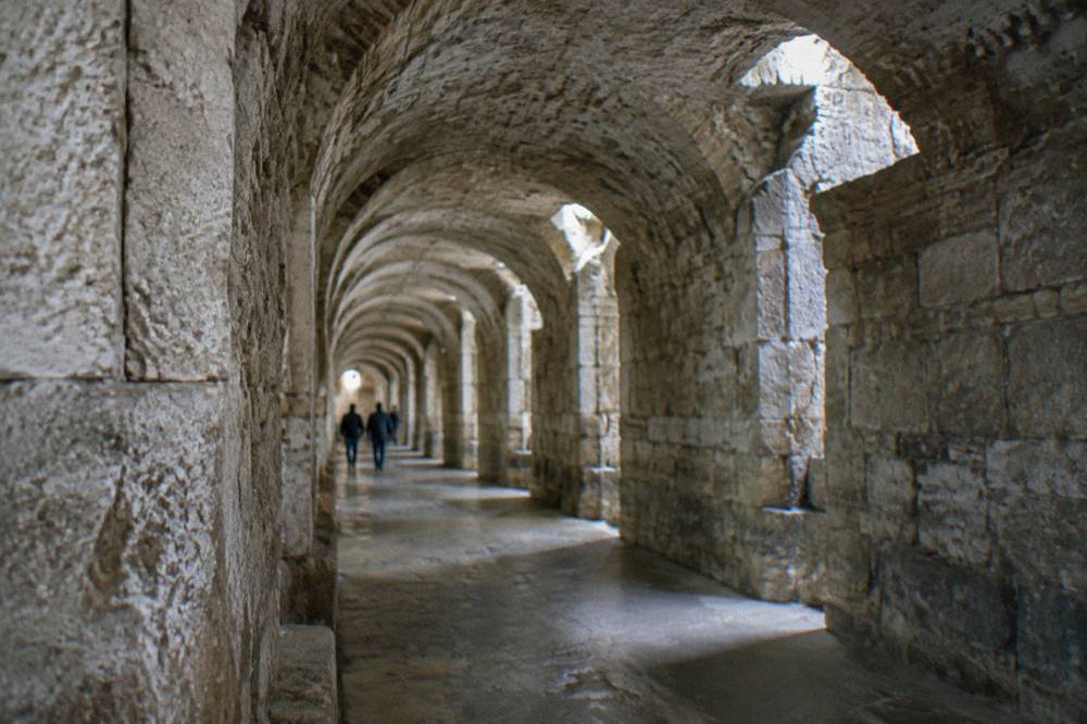 The vaulted stone corridors of Diocletian's Palace substructures lit by small openings