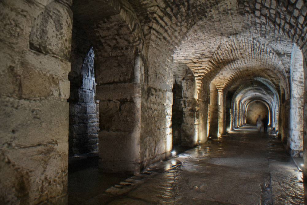 Dimly lit stone vaulted corridor of the Diocletian's Palace cellars