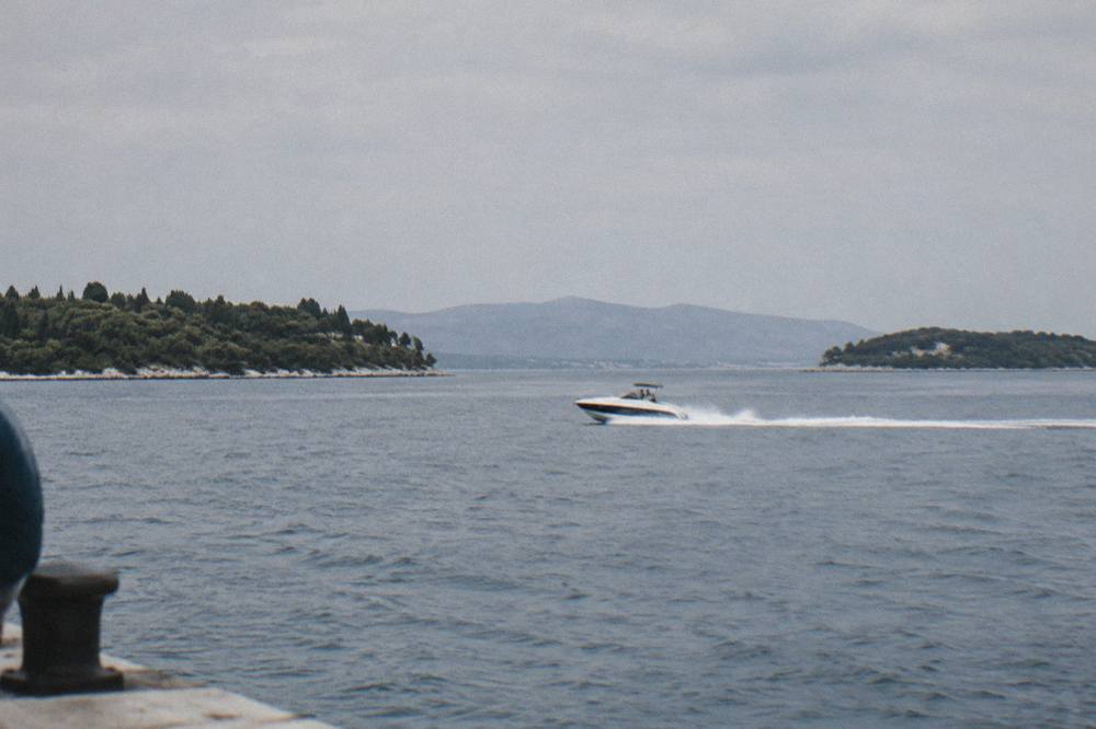 Speedboat cutting across open water between islands near Split