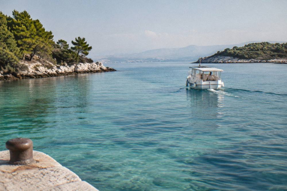 A boat on turquoise shallow water at a lagoon between islands near Split