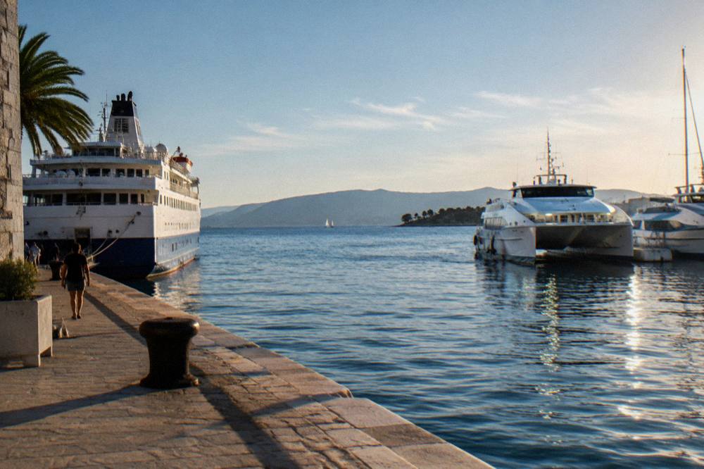 A ferry and catamarans moored at Split harbour with the Dalmatian islands in the distance