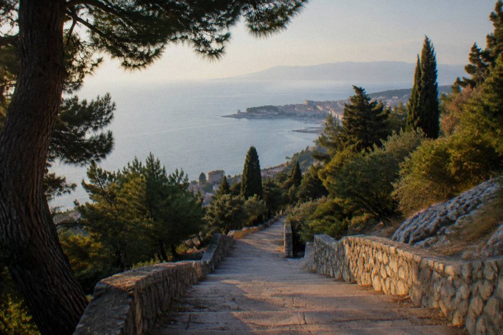 Empty stone stairs on Marjan hill above the sea in warm late afternoon light